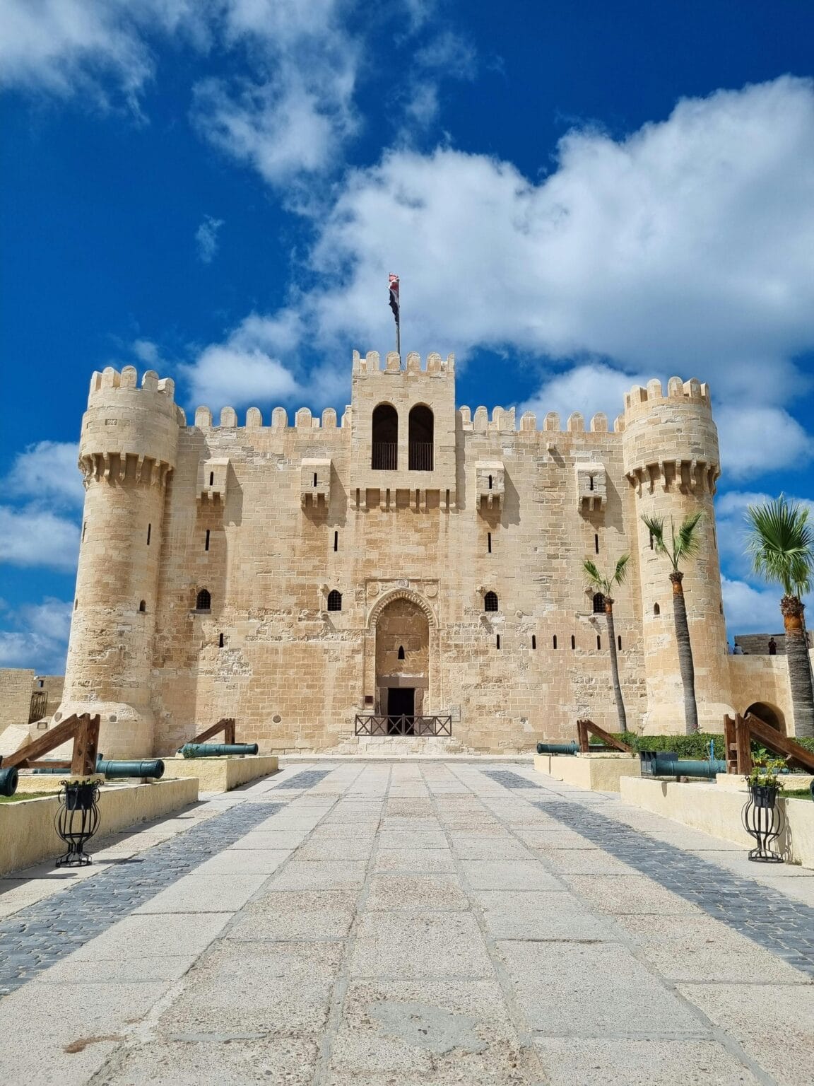 Citadel of Qaitbay fortress main entrance with defensive towers and crenellated walls Alexandria Egypt Mediterranean coast