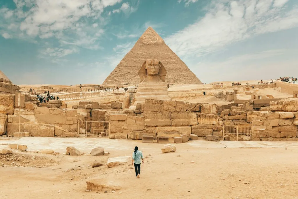 Great Sphinx and Pyramid of Khafre at Giza Pyramids complex Cairo Egypt with tourist exploring ancient ruins