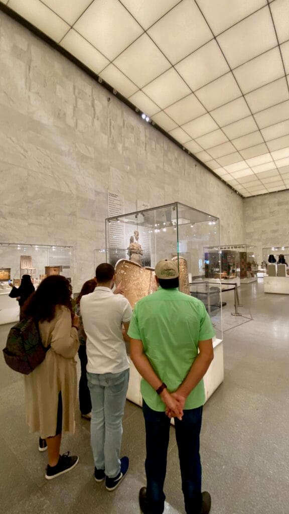 Empire Travel tour guide leading group viewing royal mummy display at National Museum of Egyptian Civilization Cairo Egypt