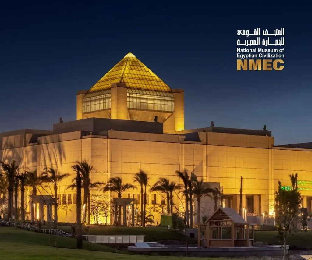 National Museum of Egyptian Civilization NMEC exterior illuminated at night with golden pyramid dome in Fustat Cairo Egypt