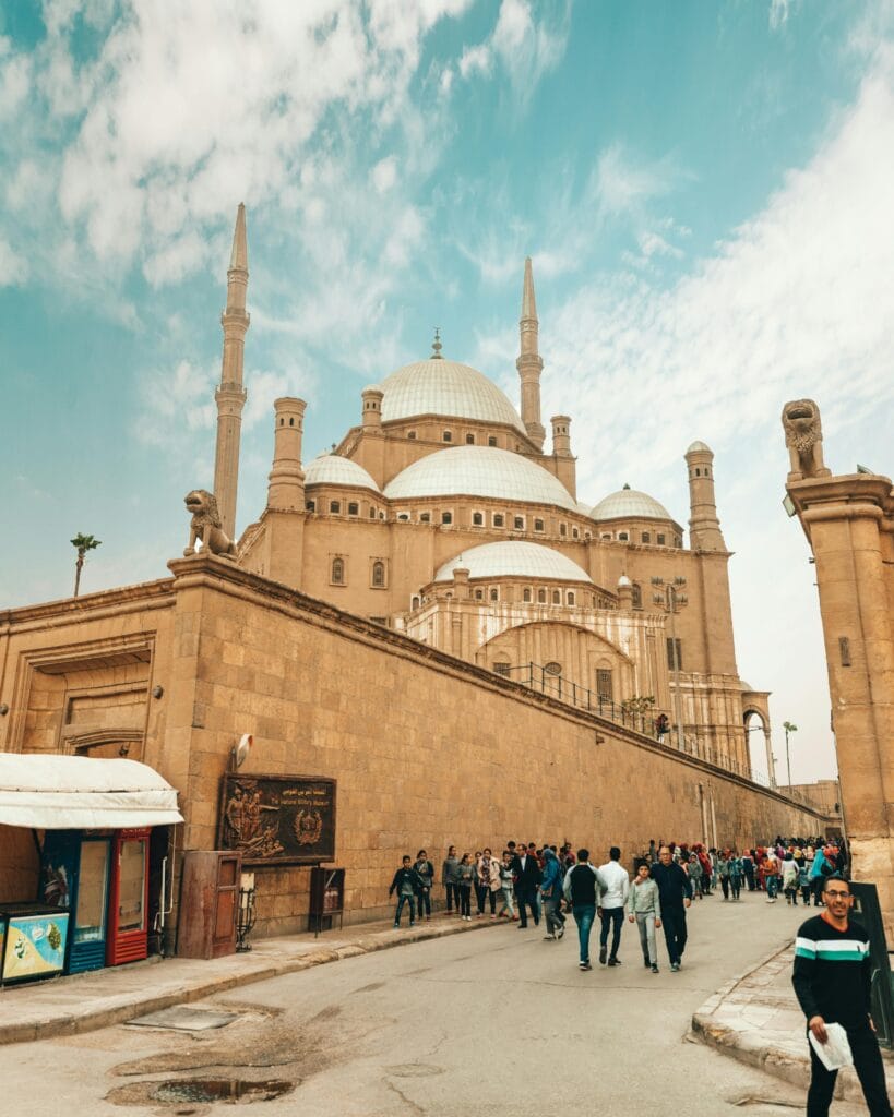 Visitors walking near the Mosque of Muhammad Ali in Cairo
