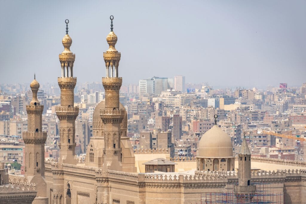 Sultan Hassan Mosque minarets overlooking Cairo cityscape