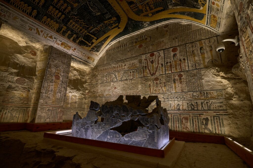 Burial chamber inside the Tomb of Ramesses VI in the Valley of the Kings showing the broken granite sarcophagus, painted walls with afterlife scenes, and the famous astronomical ceiling depicting the sky goddess Nut