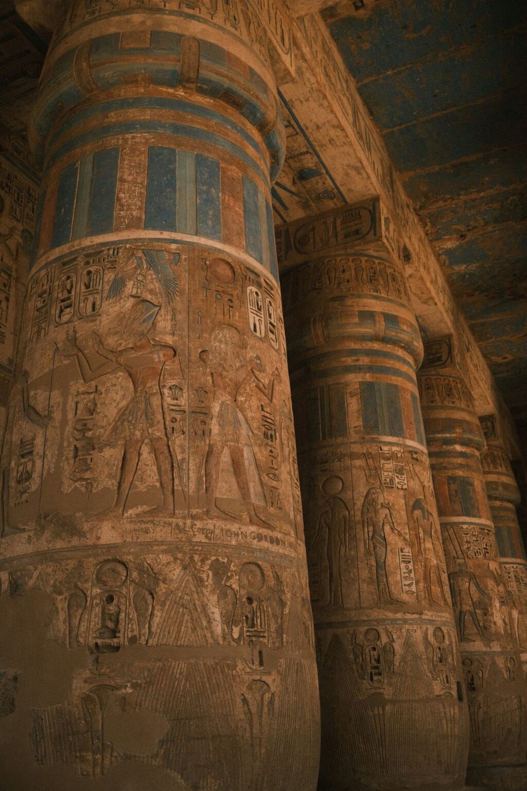 Decorated columns with hieroglyphs inside Medinet Habu Temple in Luxor Egypt