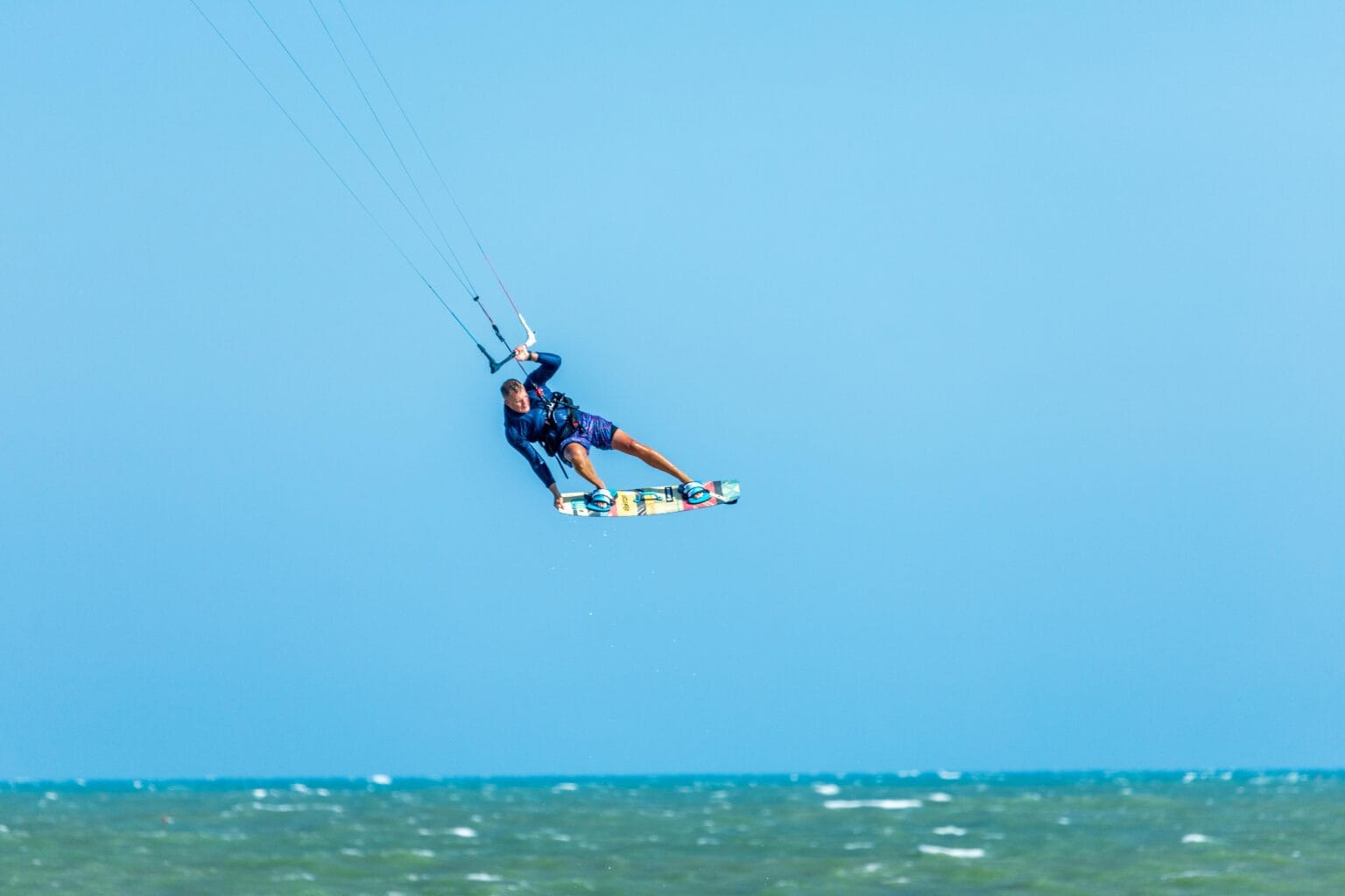 Kitesurfer performing a jump over the Red Sea near Hurghada, Egypt.