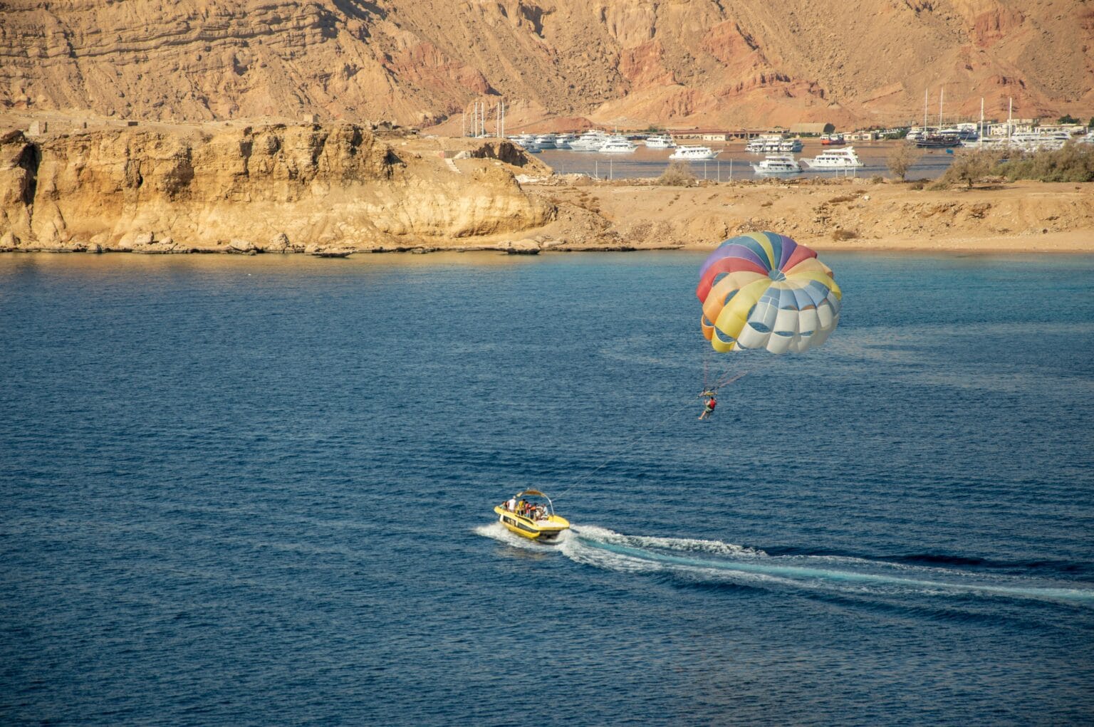Tourist parasailing over the Red Sea in Sharm El Sheikh, Egypt.