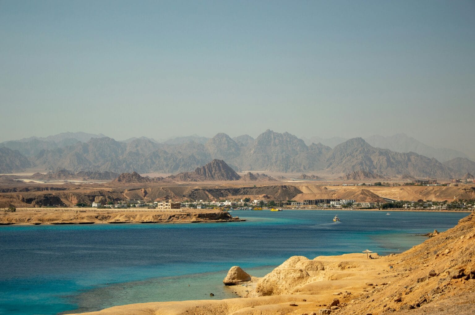 View of the Red Sea coastline and desert mountains near Sharm El Sheikh, Egypt.